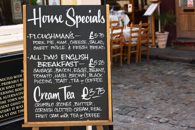 House Special menu board with a street cafe or restaurant in the background