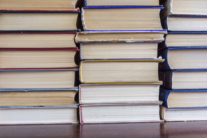 Stack of Used Old Books Background, Books of Different Thickness and Color, Many Books Piles in the School Library, Pile of Old Books Stacked on Top of Each Other, Education Background, Back to School