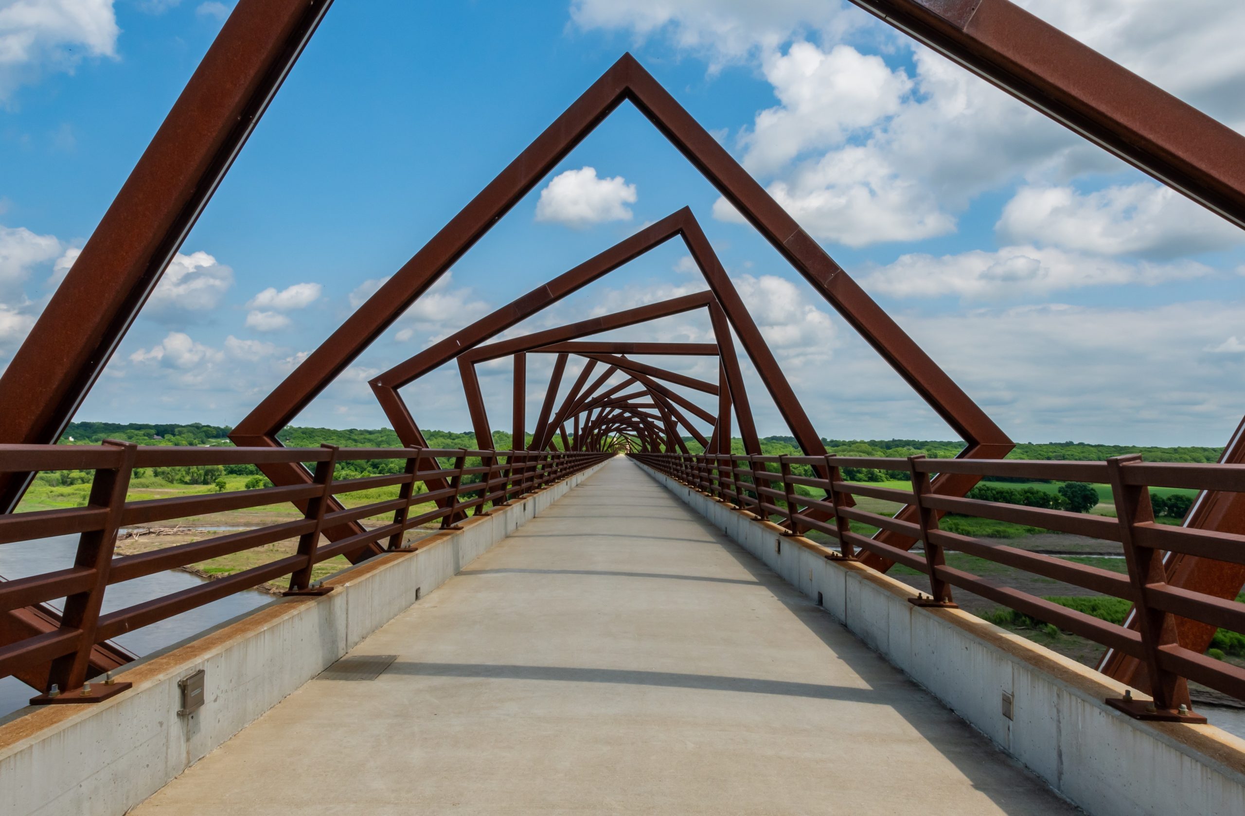 Twisting Bridge Over Rails to Trail on Sunny Day