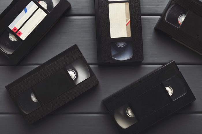 Retro video cassettes on gray wooden background. Top view on front sides. Back to the past and multimedia concept, copy space, flat lay
