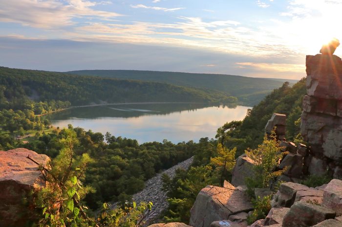 Areal view on the South shore beach and lake from rocky ice age hiking trail during sunset. DevilÃ?s Lake State Park, Baraboo area, Wisconsin, Midwest USA. Beautiful summer evening landscape.