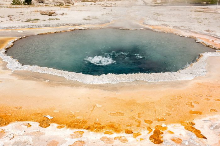 Geyser and hot spring in old faithful basin in Yellowstone National Park in Wyoming