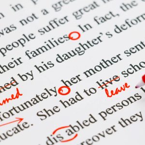 Text with red pen edits; words are crossed out, corrected, and circled. Edits highlight grammatical and spelling errors on a printed document.