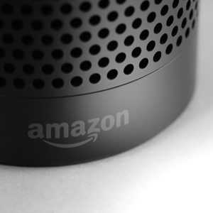 Black cylindrical speaker stands still, displaying 