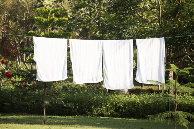 fresh clean white towels drying on washing line in outdoor