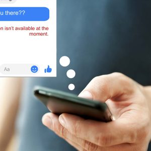 Hand holding a smartphone, displaying a chat message: 