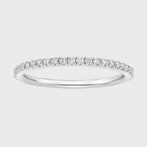 Diamond ring features small stones encircling a slender silver band, set against a plain light gray background.