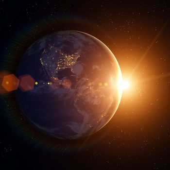 Earth partially illuminated, city lights visible, sun rising; surrounded by stars in space.