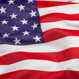 Flag, displaying stars and stripes, waves gently, emphasizing red, white, and blue colors in a patriotic context.