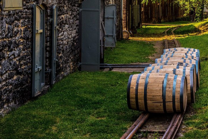 Newly filled bourbon barrels on rail to be transported to warehouse for aging in Kentucky.