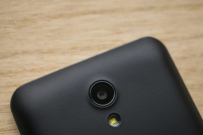 smart phone camera and flash on wood background