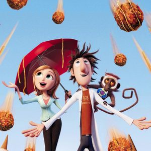 Characters gaze up, surrounded by large falling meatballs, under a clear blue sky. One character holds a red umbrella. A monkey clings to another.