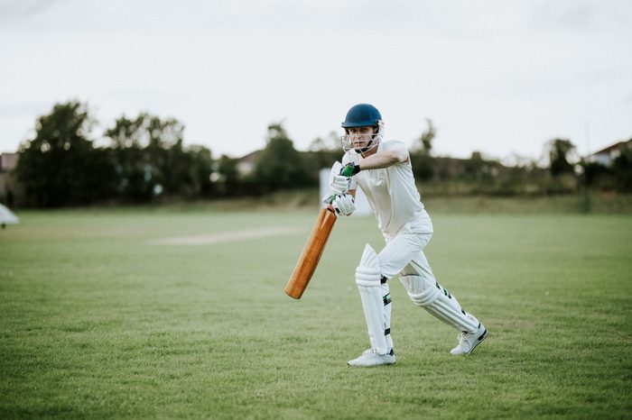Cricketer on the field in action