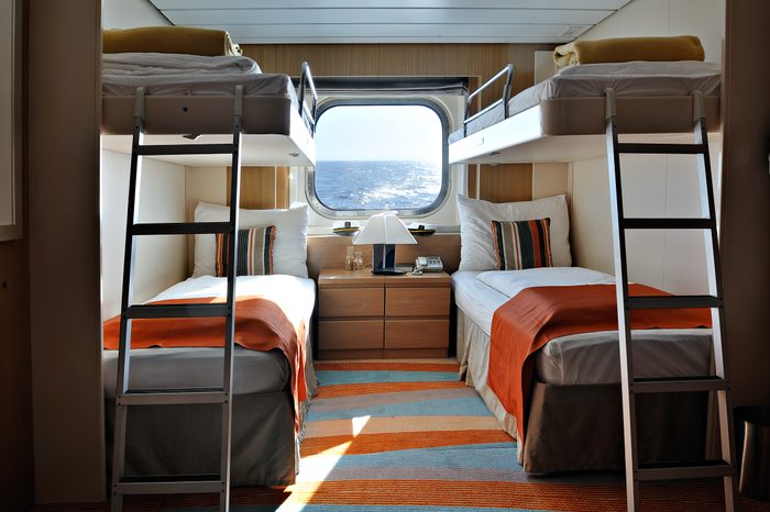 interior of a living cabin on a cruise ship - with bunk beds and window
