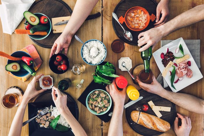 Top view, Group of people sitting at the wooden table having meal