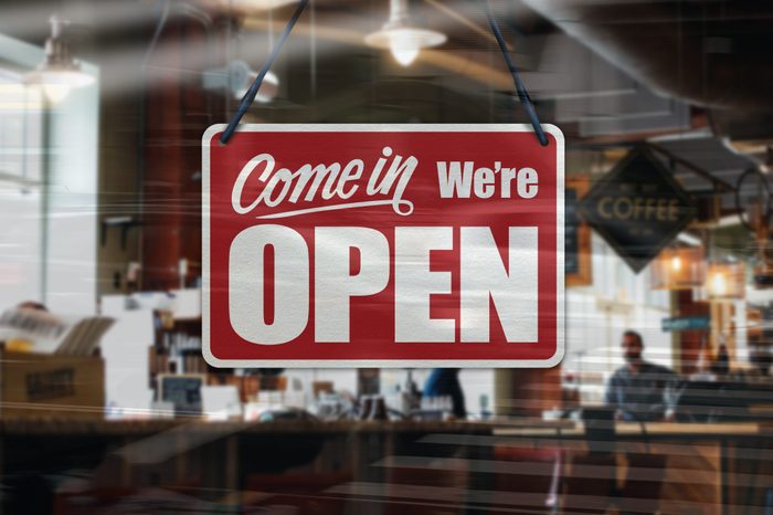 A business sign that says 'Come in We're Open' on Cafe / Restaurant window.