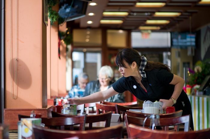Waitress clearing table