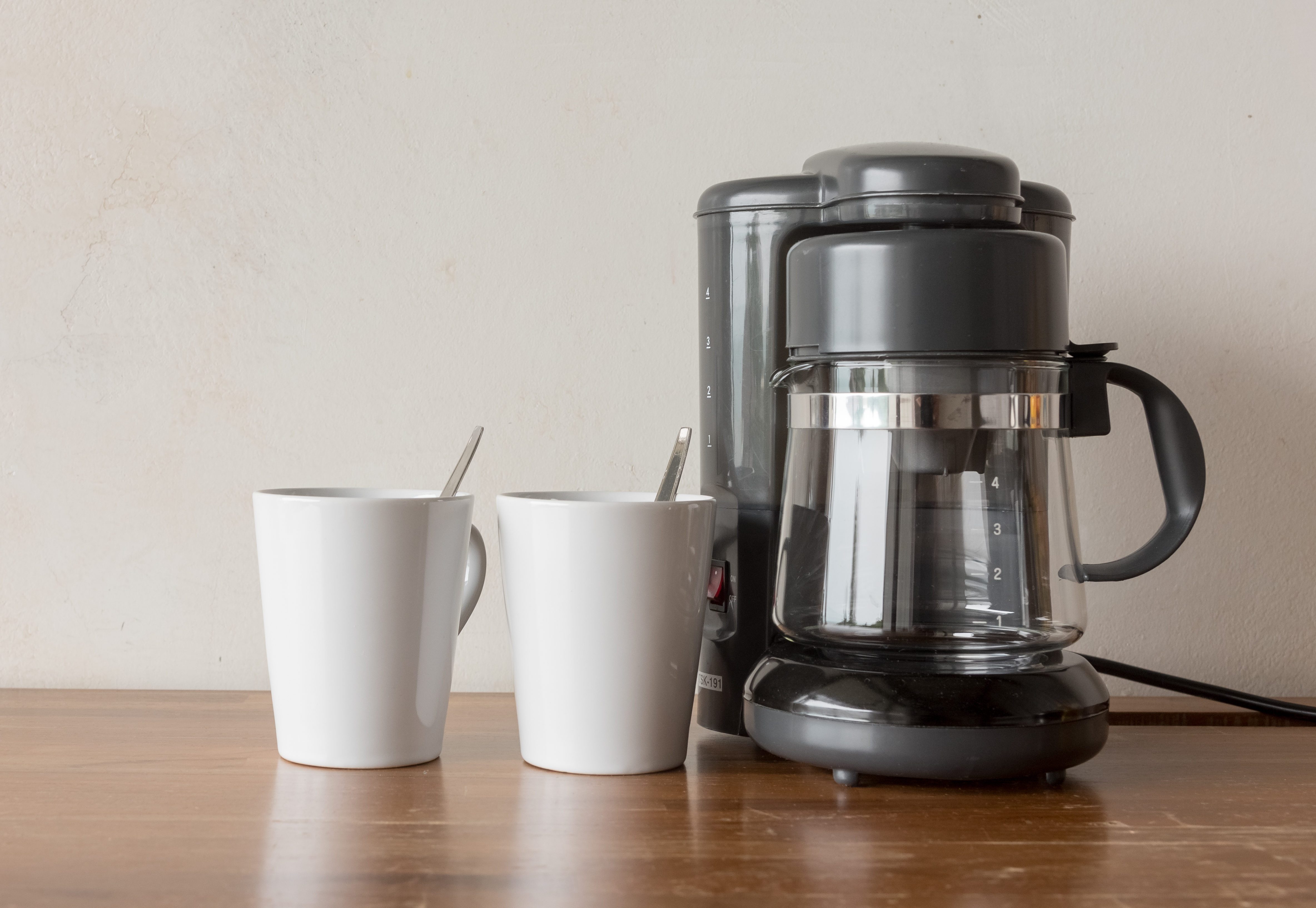 Coffee blender and boiler with coffee cups on wooden table top
