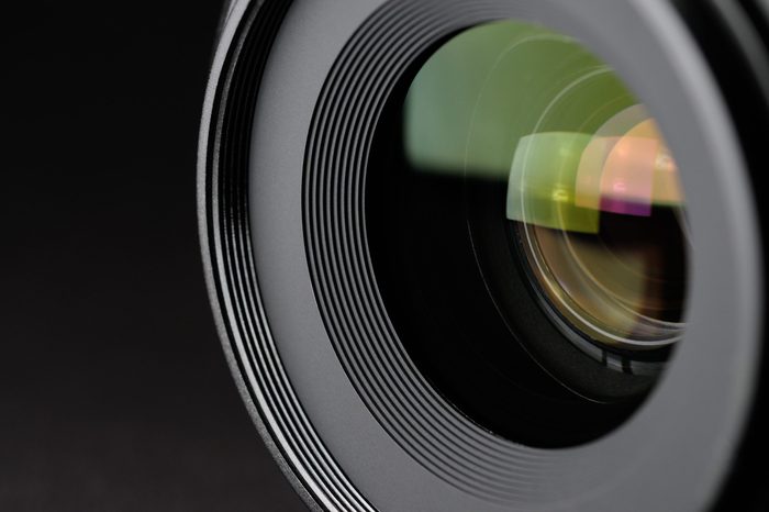 Camera lens close-up on black background