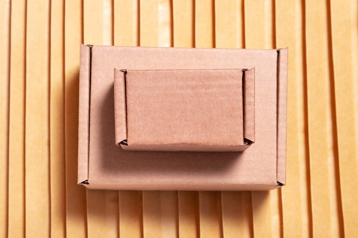 Brown cardboard box on lot of bubble envelopes