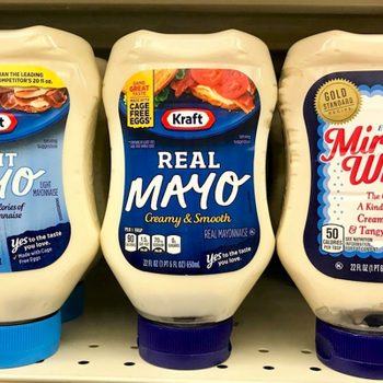 Three mayonnaise bottles stand on a grocery shelf: Light Mayo, Real Mayo, and Miracle Whip. Each promises a unique taste experience.
