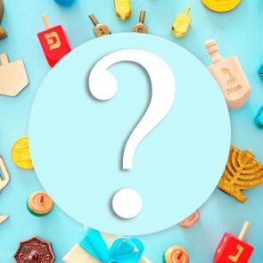 Question mark centered on blue circle, surrounded by Hanukkah items like dreidels, menorahs, and gelt on a blue background.