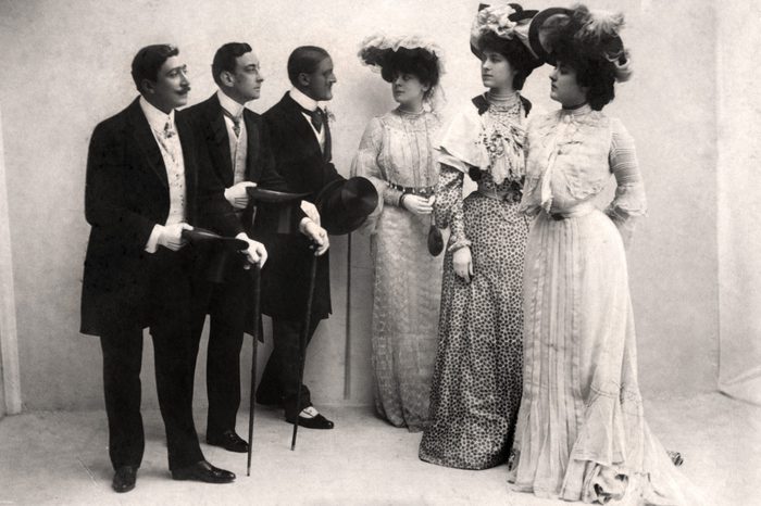 three men stand next to three women