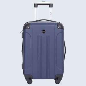 Blue suitcase with a retractable handle stands upright, featuring wheels and the text 