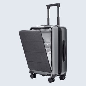 A gray suitcase with an open front compartment reveals organized interior pockets, situated on a plain background.