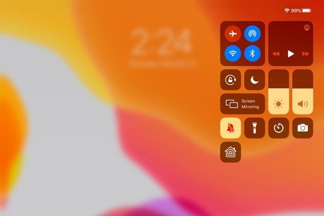 Control Center screen displays icons for connectivity, brightness, volume, and shortcuts on a blurred, multicolored orange and yellow background. Time reads 2:24.