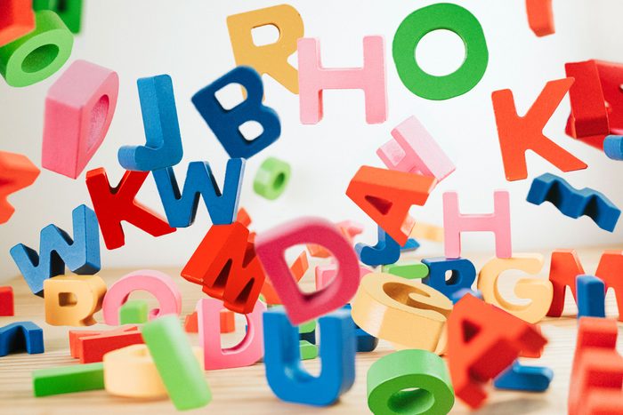 colorful letter blocks falling onto a table