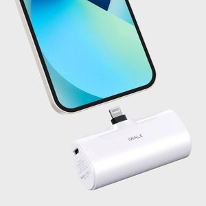 Portable charger connecting to a smartphone in a minimalistic setting. The charger is labeled 
