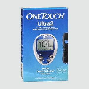 Box displays a blood glucose meter showing reading, surrounded by blue packaging. Text includes brand name 