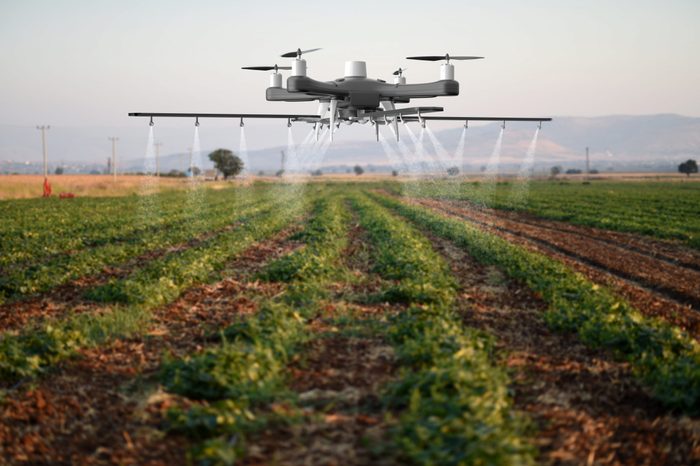 Drone spraying a field