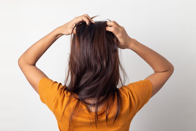 Women itching scalp itchy his hair and was massage her hair on a white background,Haircare concept