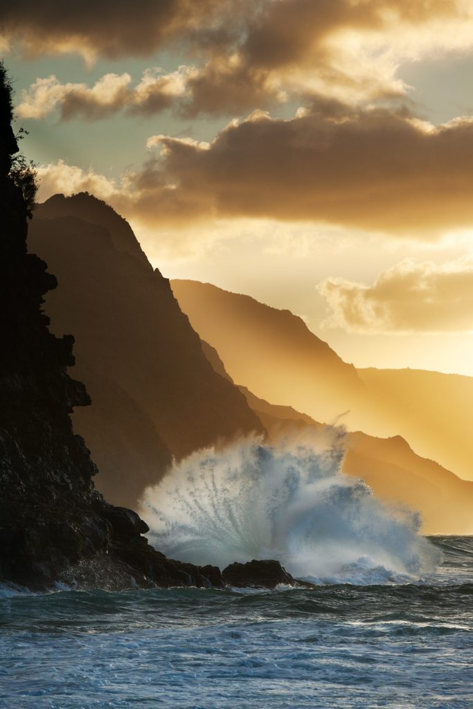 Surf smashing into Na Pali coast in Hawaii.