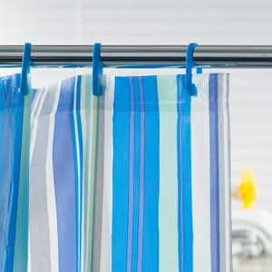Striped shower curtain hangs from blue hooks on a metal rod; bathroom items are blurred in the background.