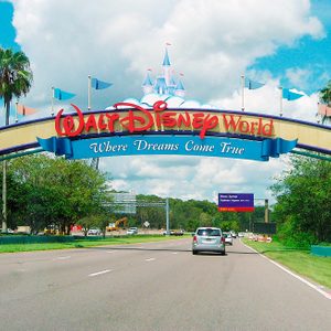 A colorful archway welcomes vehicles, displaying 