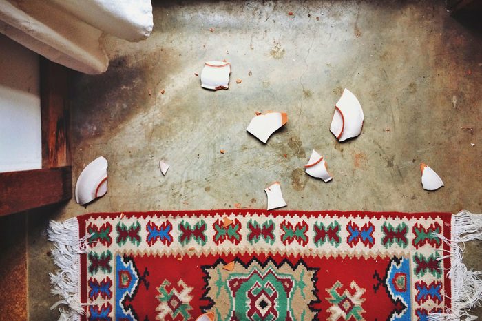 Directly Above Shot Of Broken Plate By Carpet At Home