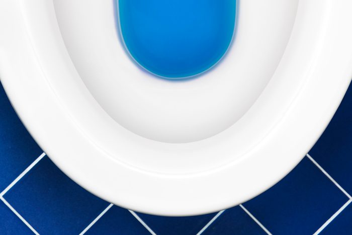Toilet on blue tile