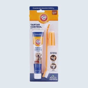 Tartar control toothpaste and toothbrush for dogs, featuring baking soda formula, shown in packaging with before-and-after results images, promoting dental hygiene.