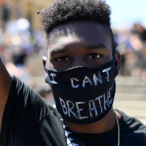 Person wears a mask reading 