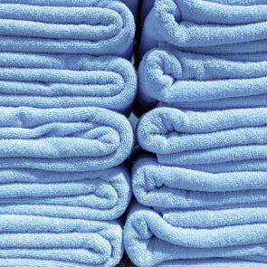 Blue towels are neatly folded in stacks, creating a tidy and organized appearance.
