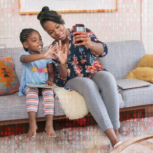 Child and adult smile, waving at camera while sitting on a sofa in a cozy living room. Red binary code overlays the scene.