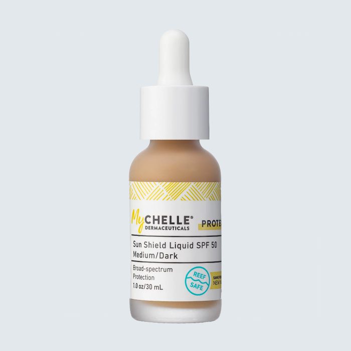 A dropper bottle contains MyChelle Sun Shield Liquid SPF 50, labeled 