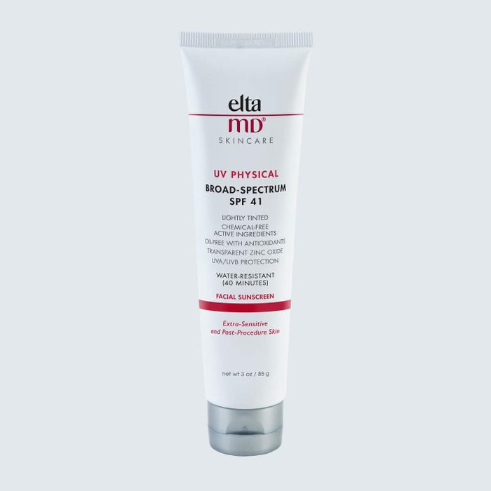 A white tube of sunscreen stands vertically on a plain background, labeled 