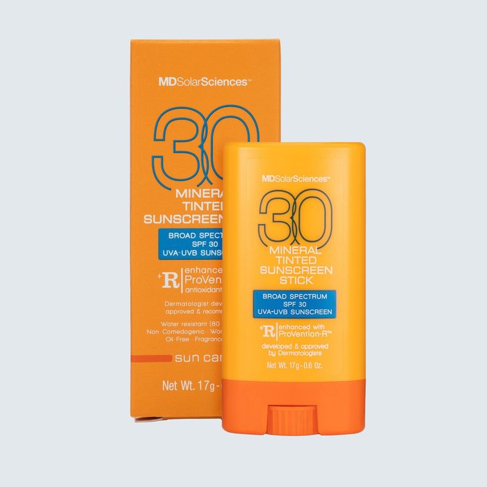 Orange sunscreen stick labeled 
