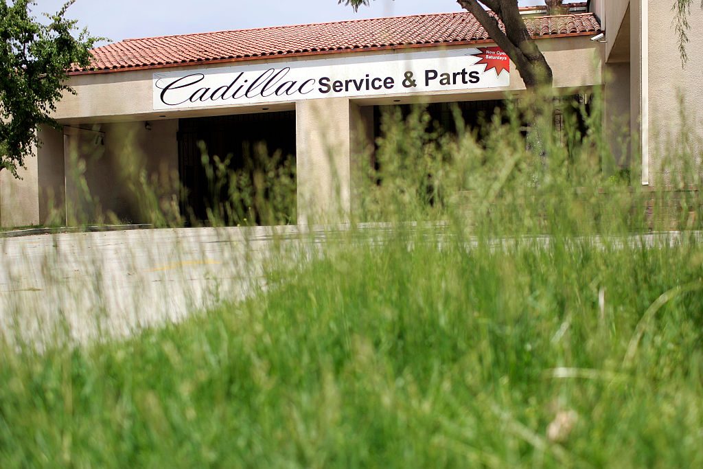 Weeds have taken over the landscape at the closed Kennedy Cadillac dealership off Camino Real in Sa