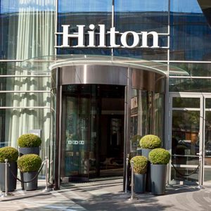 Revolving glass door opens at a modern hotel entrance with 