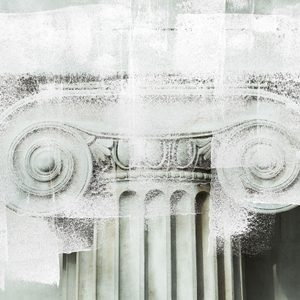 Ionic column capital, partially obscured by white abstract paint, against a textured neutral background.